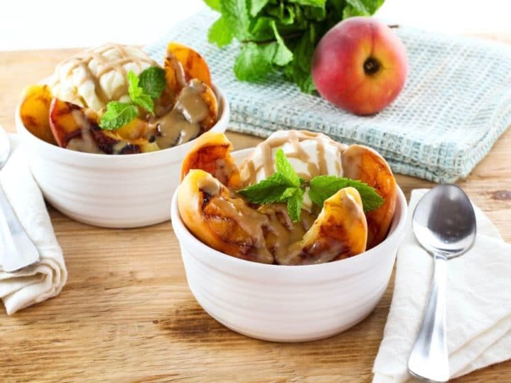 Grilled Peach Sundae with Brandy Butterscotch Sauce - Recipe for grilled ripe peaches and creamy caramelized sauce over vanilla frozen yogurt. 
